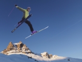 Skier jumping across skyline