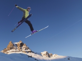 Skier jumping across skyline