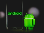 The Bugdroid standing beside an android smartphone.