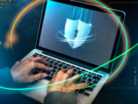 A man using a laptop with security icon on display.