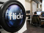 Flickr logo printed on lens of a camera.