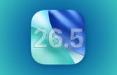 iOS 26.5 software update icon featuring a stylized blue and teal folded design with the version number 26.5 in transparent glass lettering.