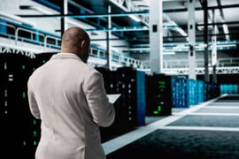 Technician in data center workspace running diagnostic tests, increasing uptime