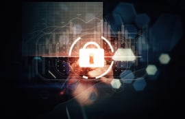 Cybersecurity concept image of a glowing digital padlock icon over financial data charts and a human hand.