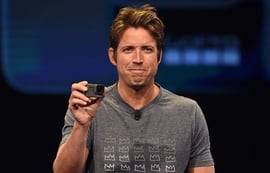 GoPro CEO Nick Woodman holding a GoPro Hero camera during a product launch event.