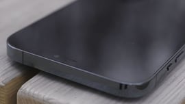 Close up of iPhone on wood plank tabletop.