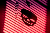 Skull shadow on red background.