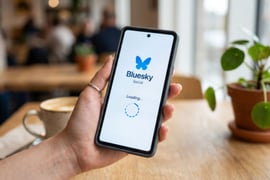 smartphone with bluesky logo on screen