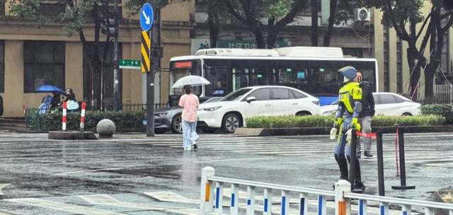 China Tests Humanoid Robots to Direct Traffic in Heavy Rain